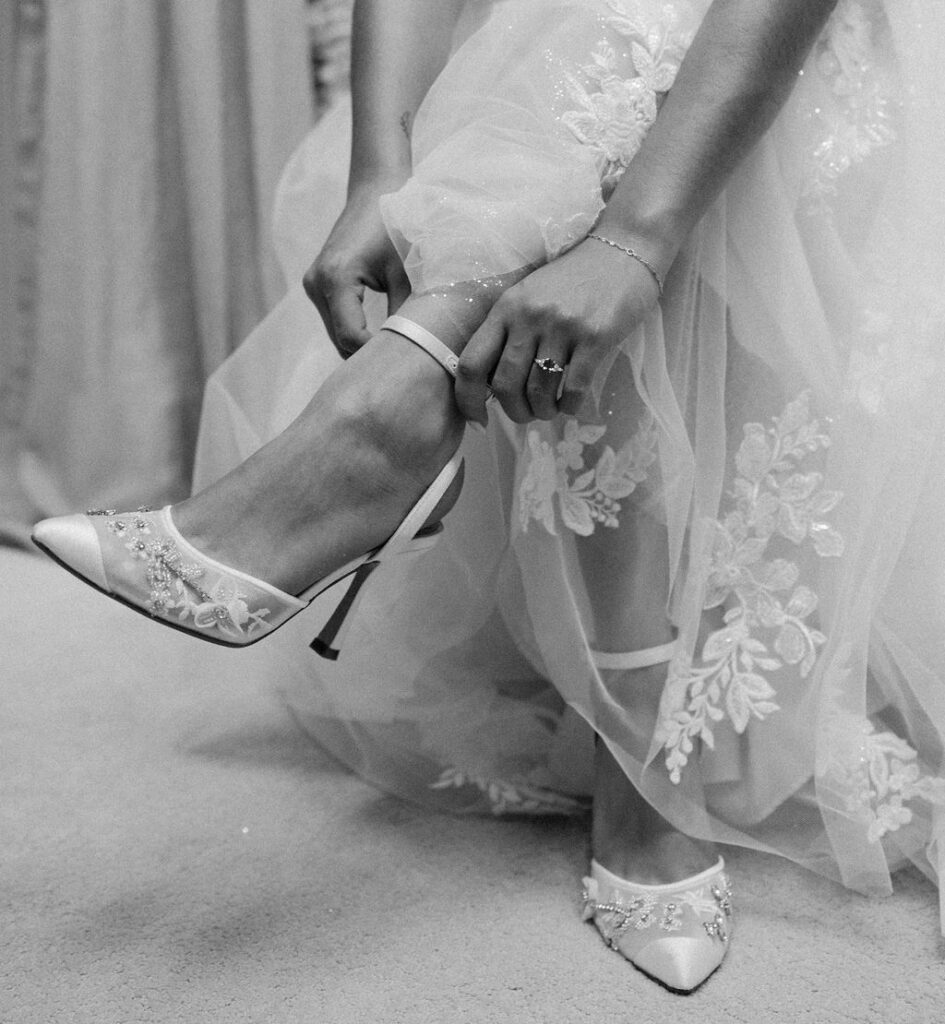 Bride putting wedding shoes on