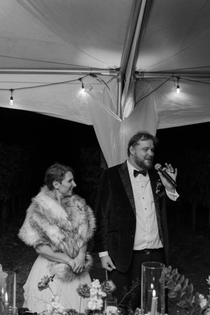 Bride and groom giving speech at wedding