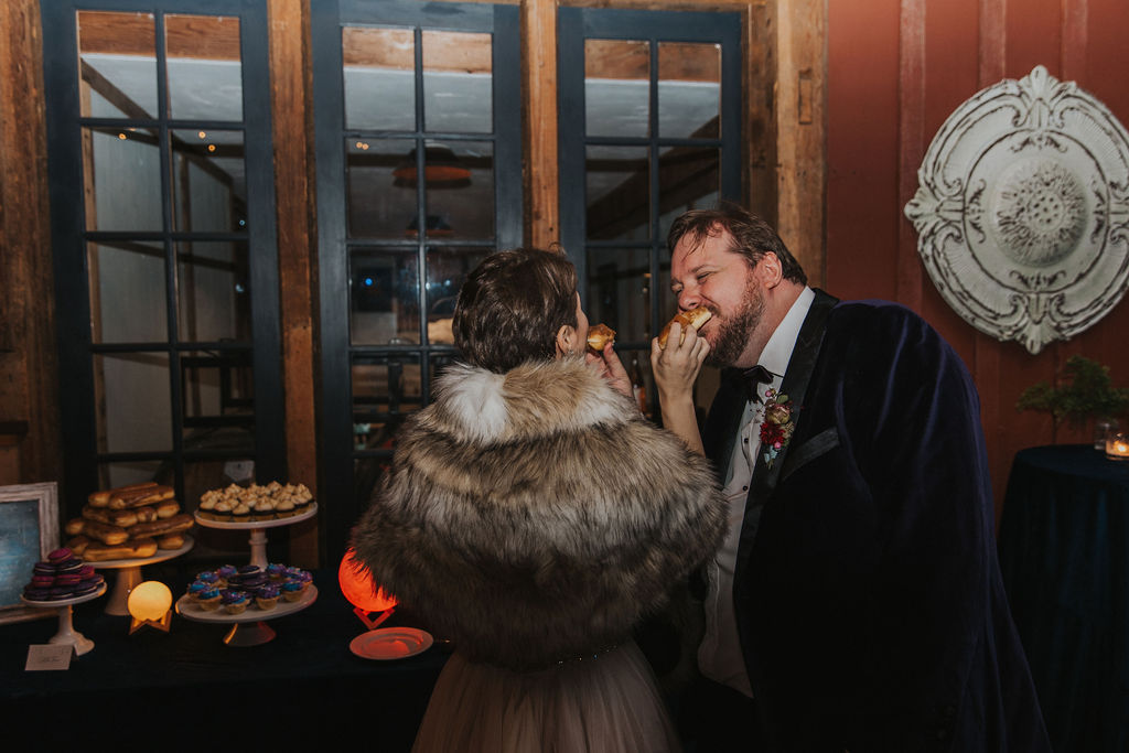 Bride and groom sharing donut