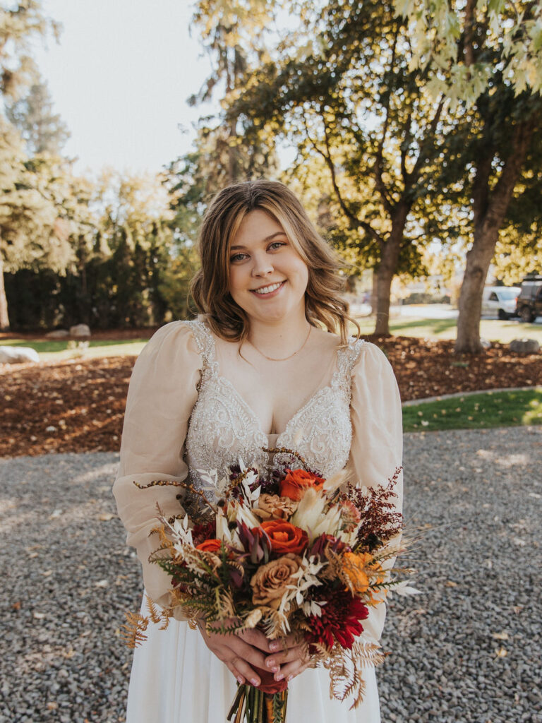Bride holding fall wedding bouquet