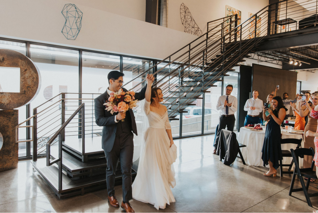 Bride and groom entering the reception at Space Gallery, wedding venue in Denver