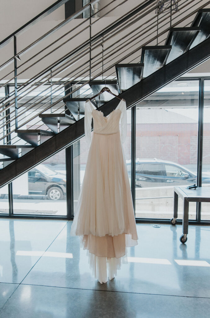 Wedding dress hanging from stairs