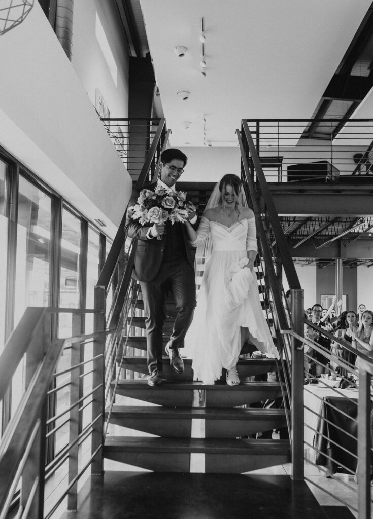 Bride and groom entering the reception at Space Gallery, wedding venue in Denver