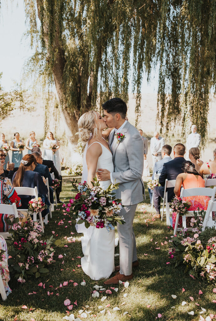 Romantic summer wedding ceremony at an outdoor riverside wedding venue