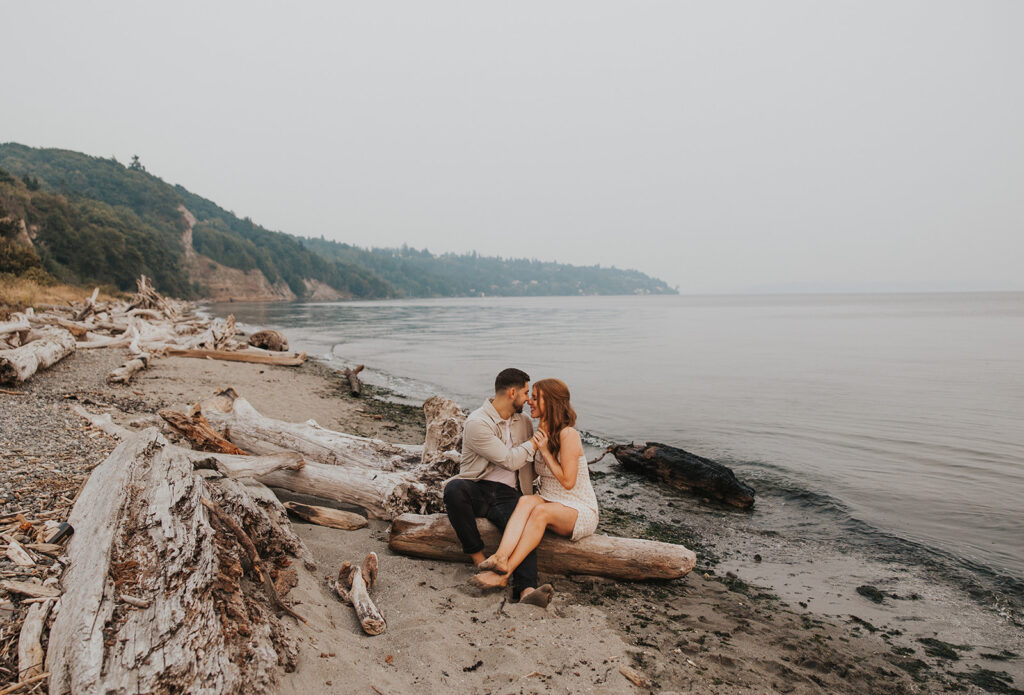 Playful Discovery park engagement photos with beach in the backdrop