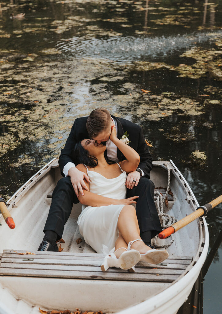 romantic wedding portrait in a row boat