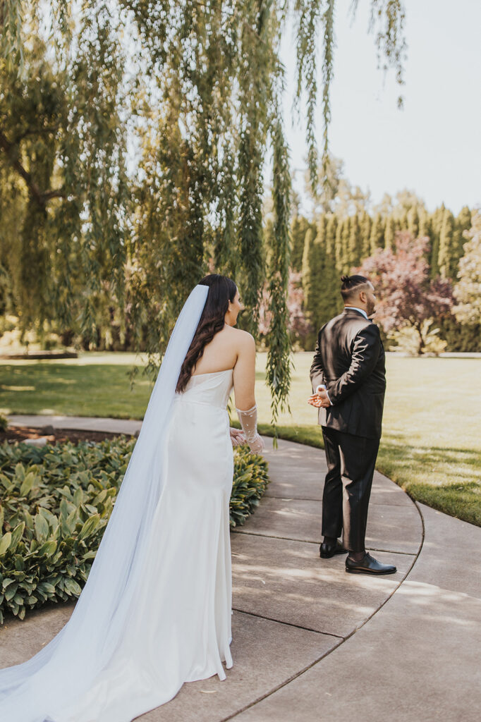 romantic bride and groom first look outdoors by a weeping willow