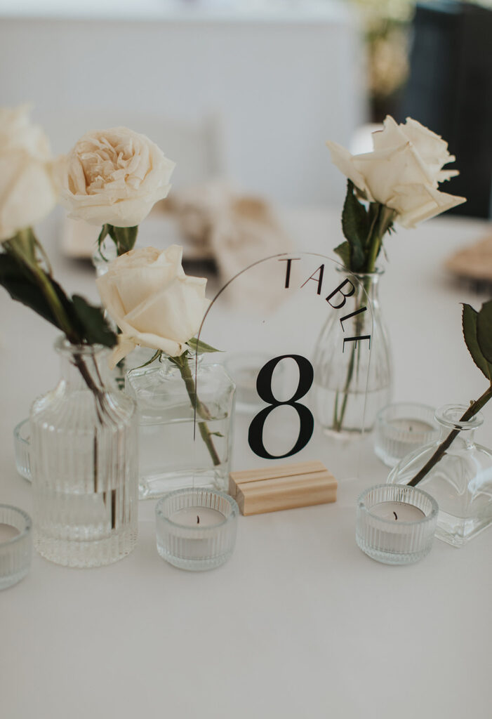 elegant all white reception decor with white roses