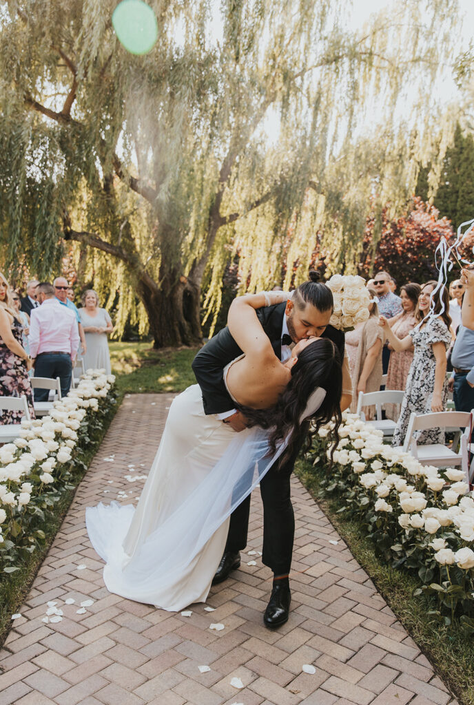romantic outdoor wedding ceremony with a weeping willow in the backdrop at Promise Garden WA