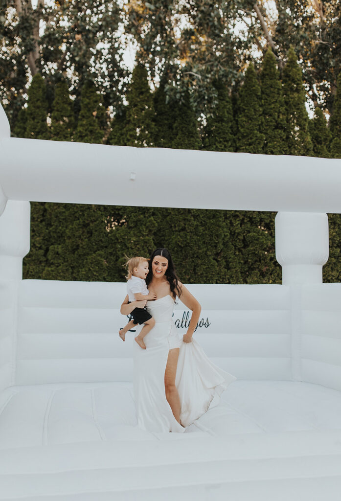 bride and a kid on a white bouncy castle