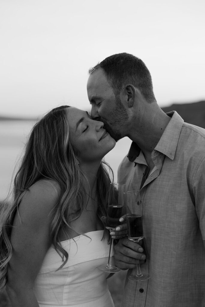 Couple celebrates with champagne during their summer engagement session