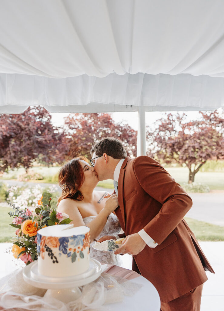 Couple cutting cake at their outdoor Wedding and Reception