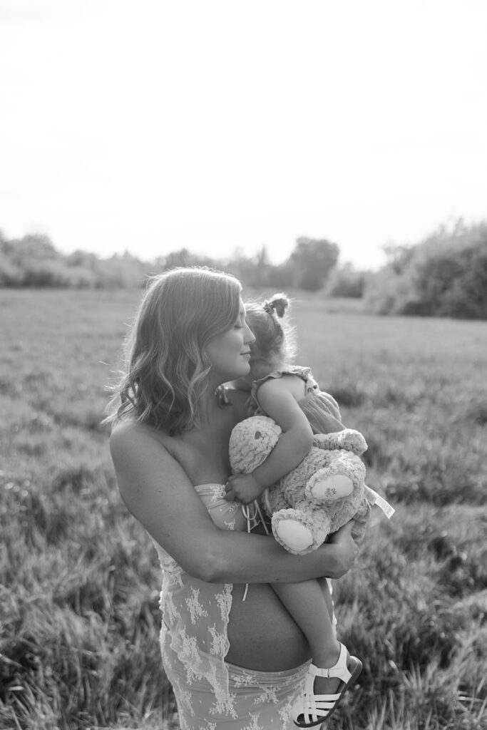 Mother and daughter snuggle up during golden hour family photos