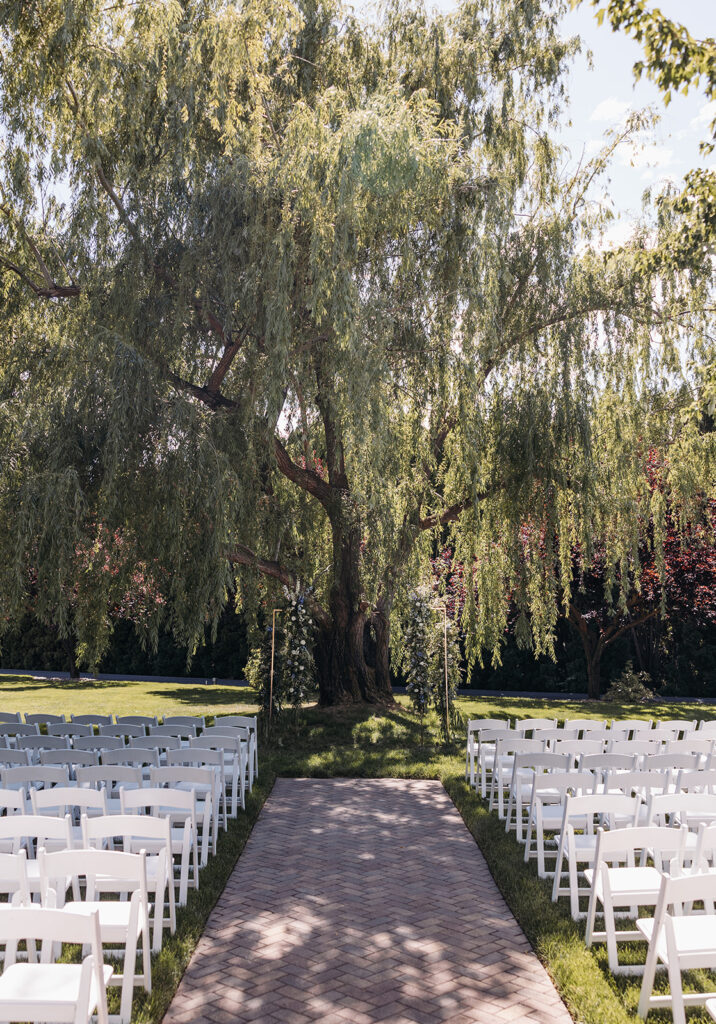 The Promise Garden ceremony setup with elegant floral arrangements and a picturesque arch.