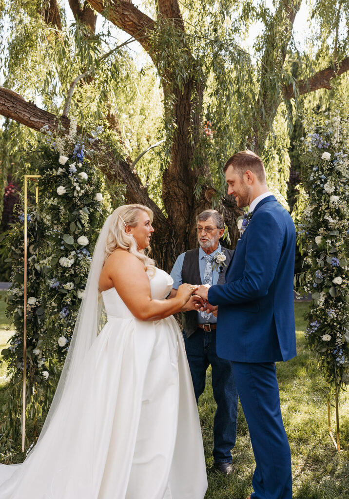 Samantha and Austin exchanging vows in the Promise Garden, with guests looking on.