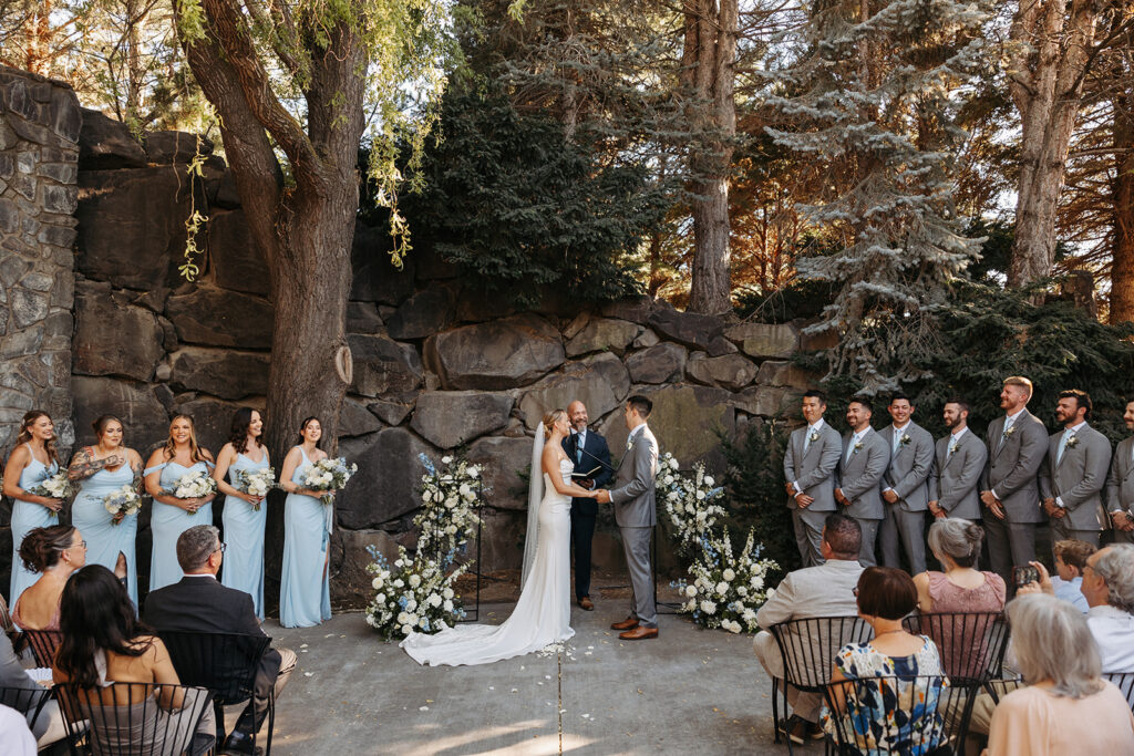 Romantic wedding ceremony at Terra Blanca Winery, surrounded by elegant blue and white florals.