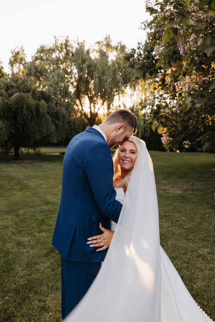 The sun setting behind Samantha and Austin as they share a private moment in the Promise Garden.