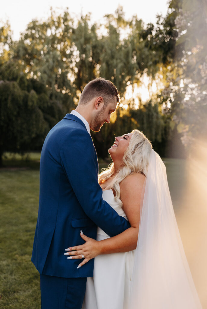 The sun setting behind Samantha and Austin as they share a private moment in the Promise Garden.