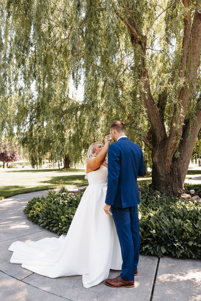 Samantha and Austin sharing a tender moment during their first look in the Promise Garden.
