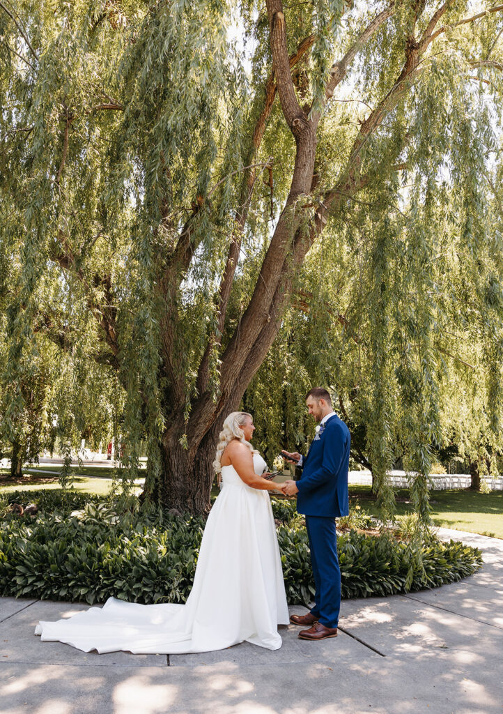 Samantha and Austin sharing a tender moment during their first look in the Promise Garden.
