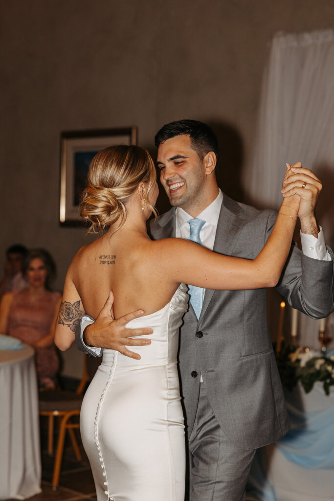 Couple’s fun first dance in a picturesque reception setting.