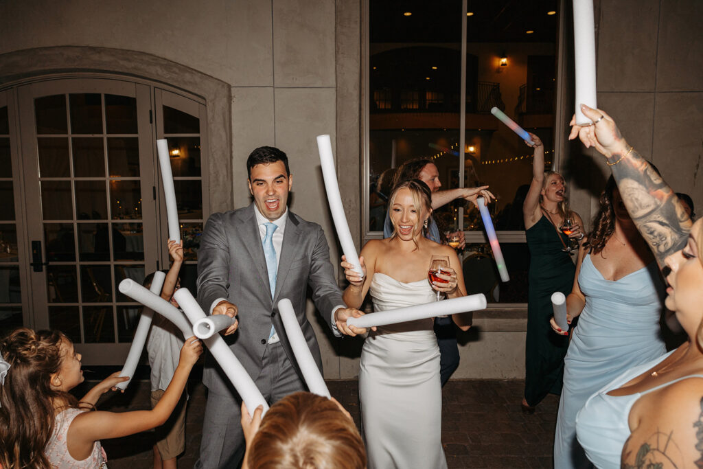 A fun and exciting wedding reception dance floor with glow sticks.