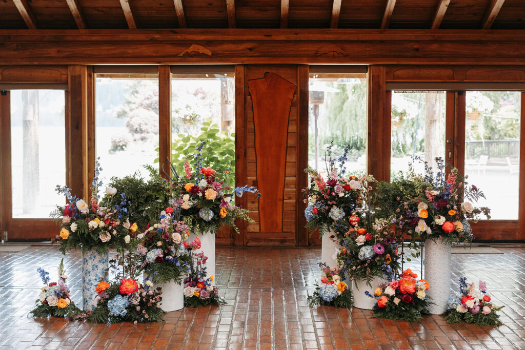 A stunning colorful wedding floral installation for the altar in Kiana Lodge