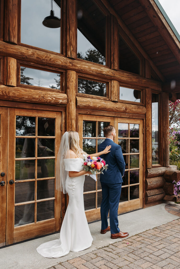 Bride and groom, first look in front of Kiana Lodge