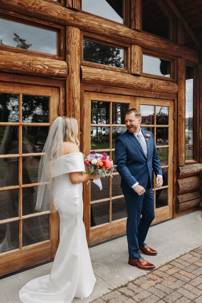 Bride and groom, first look in front of Kiana Lodge