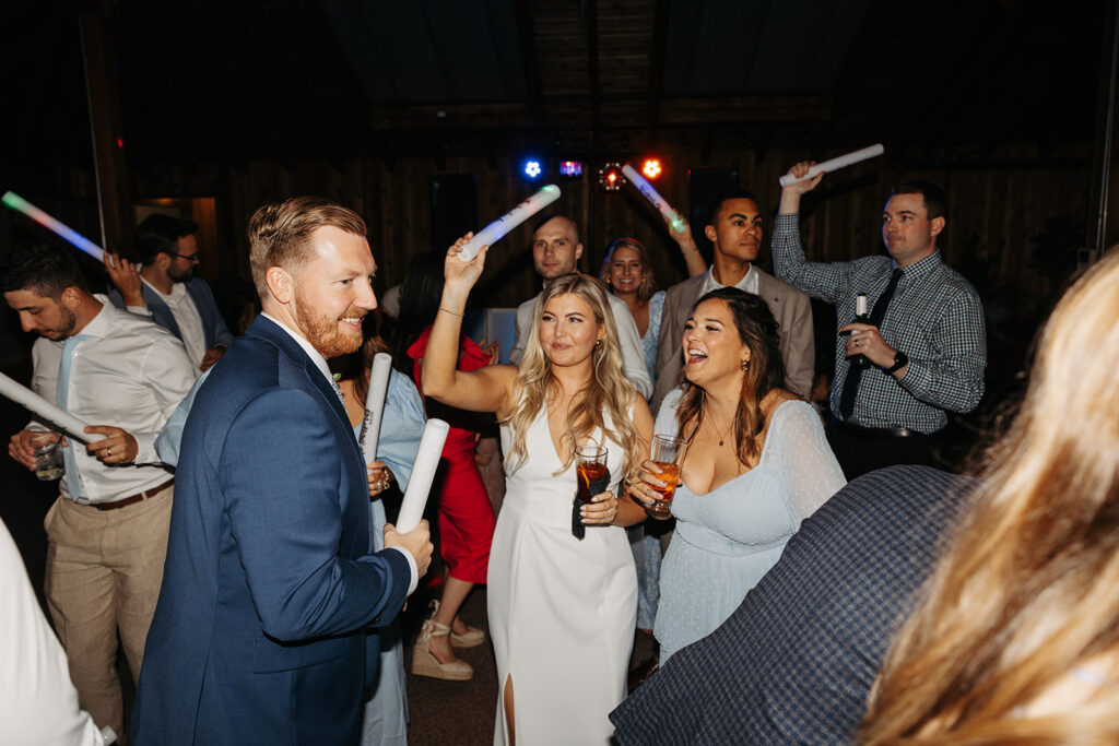 Bride and groom party with their wedding guest during the reception at Kiana Lodge