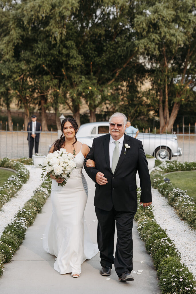 Bride and her father walk down the aisle at a Moore Mansion wedding ceremony