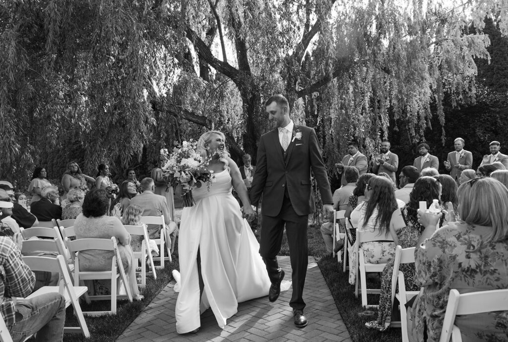 Bride and groom walk down the aisle at their Promise Garden wedding ceremony