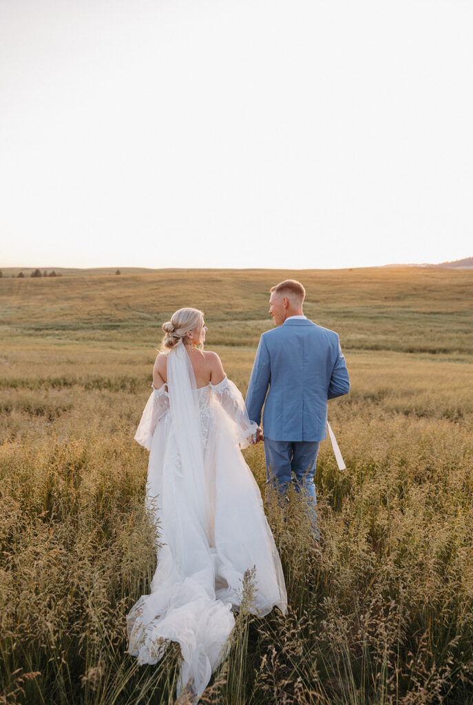 Sunset wedding portraits in a field by The Greenhouse on Harvard