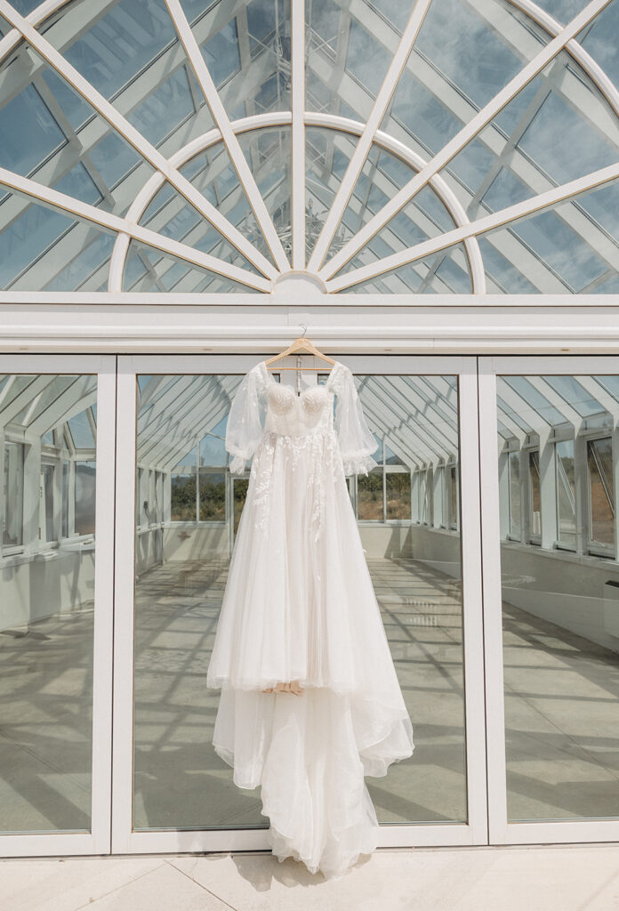Dress hanging at a greenhouse wedding venue in Spokane, Washington