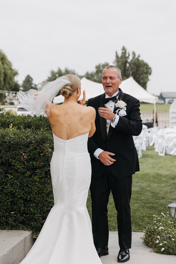 An emotional first look in front of a Tri-Cities wedding venue: The Moore Mansion