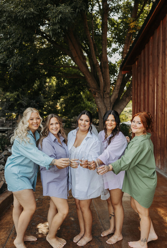 Bride with bridesmaids wearing colorful robes