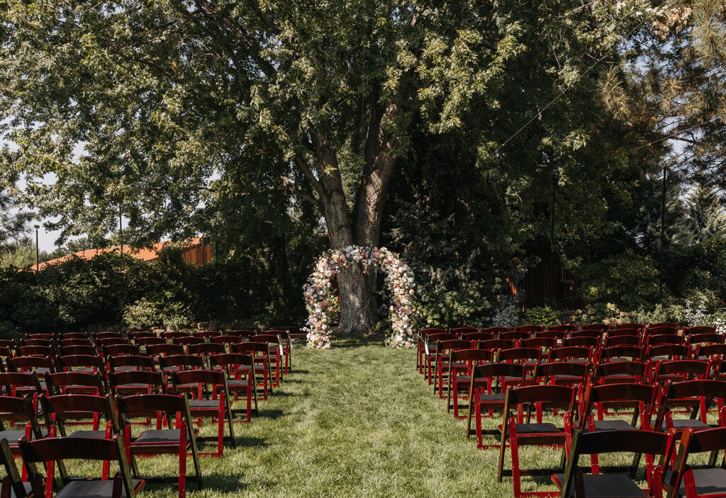 Wedding ceremony setup with colorful pastel floral arch