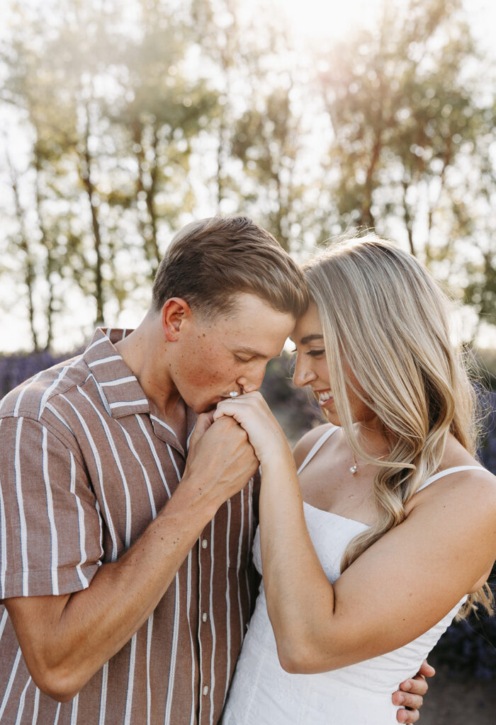 Couple sharing an intimate moment outdoors, photographed with a candid editorial wedding photography approach.