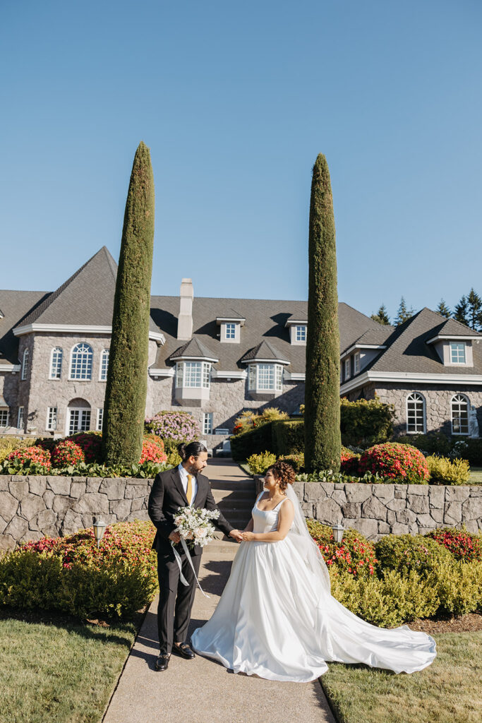 Bride and groom portraits in front of Château de Michellia in Oregon