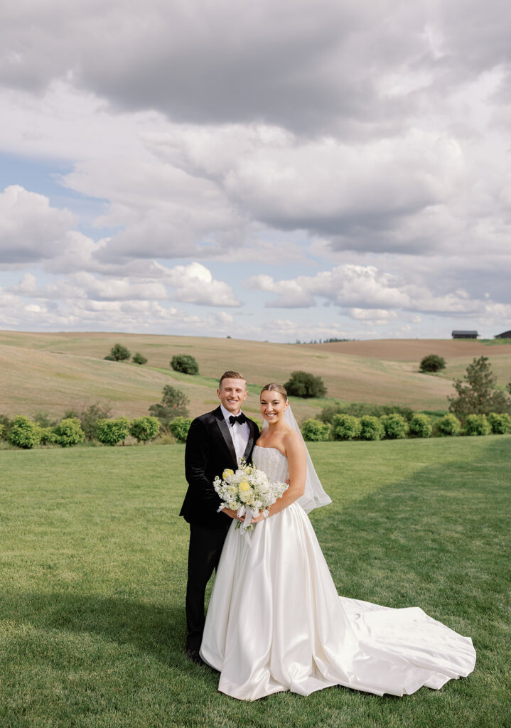 Bride and groom portraits at Greenhouse on Harvard with rolling green hills in the backdrop