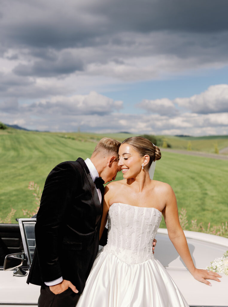 Bride and groom portraits at Greenhouse on Harvard with a vintage convertible and rolling green hills in the backdrop